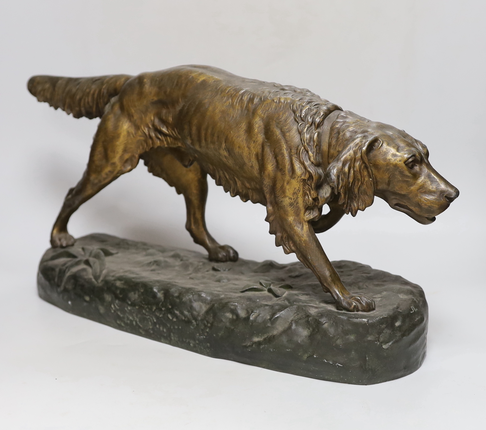 A painted spelter model of a retriever, 49cm wide, 29cm high